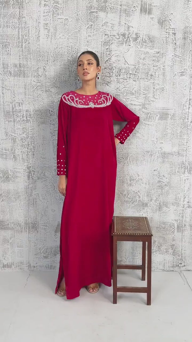 VIDEO: A cinematic fashion reel featuring a woman modeling a ruby red velvet maxi dress. 
