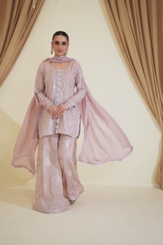 Video of model showcasing Zelara dusty pink thread‑work Eid and wedding set with panni, sequins, mirror work, pearls, and crystals, moving to highlight kurta, raw silk pants, and dupatta
