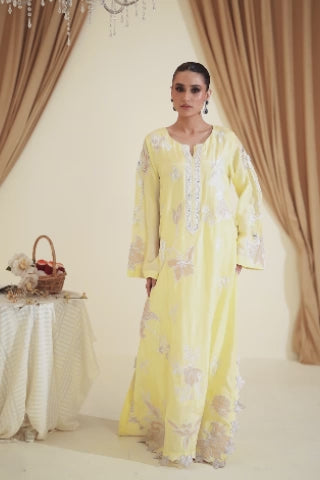 Video of model showcasing Valeh vibrant yellow tassar silk set with floral appliqué, pearls, and crystal detail, moving to highlight kurta, pants, and dupatta by Shireen Lakdawala.

