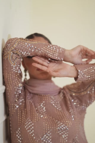 Video of model showcasing Merelia soft pink chiffon wedding set with cutwork tilla, crystal embellishments, and sequin dupatta, highlighting anarkali and festive detailing by Shireen Lakdawala.
