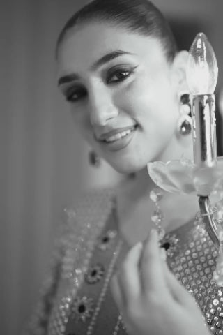 Video of model showcasing Sonea deep beige chiffon set with navy velvet handwork, tilla, sequins, and crystal detail, moving to highlight kurta, pants, and silk dupatta by Shireen Lakdawala.
