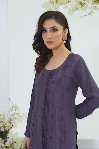 Video of a model moving gracefully in Aemari, purplish grey tassar silk ensemble, walking and turning while tossing sheer silk lace dupatta into the air. 

