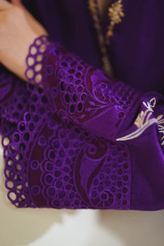 Video of model walking indoors in Ansy electric purple tassar silk set, shown from different angles with floral appliqué, crystal detailing, and ombre dupatta flowing in motion.
